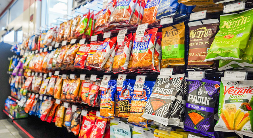 Row of salty snack selections at Denali Express Chevron.